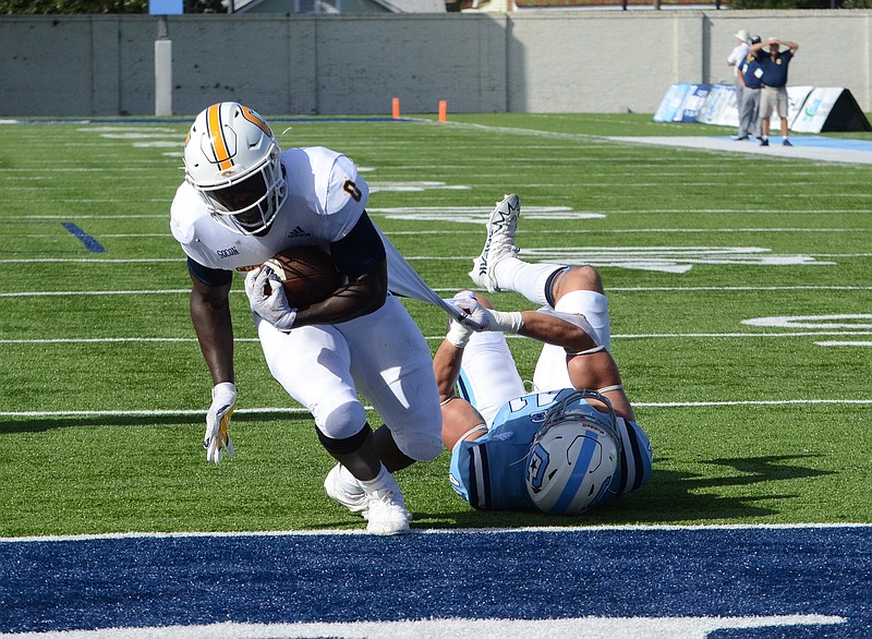 UTC Athletics by Laura O’Dell / UTC running back Ailym Ford pulls a defender as heads to the end zone during Saturday's SoCon game against The Citadel in Charleston, S.C. Ford, who missed last weekend's close loss at Furman, totaled nearly 200 yards of offense against the Bulldogs.