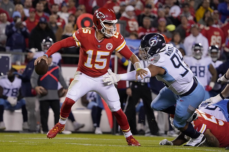 AP photo by Ed Zurga / Kansas City Chiefs quarterback Patrick Mahomes scrambles under pressure from Tennessee Titans defensive end DeMarcus Walker during the first half of Sunday night's game in Kansas City, Mo.