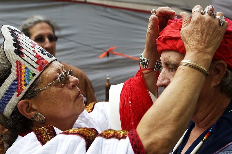 Staff photo / T.S. Madison, also known as Grandmother Elk, helps adjust Michael Hazzard's regalia during the Red Clay Pow Wow at Red Clay State Historic Park on Sunday, Oct. 27, 2019 in Cleveland, Tenn. The Pow Wow, which included traditional Native American dance and music, was sponsored Friends of Red Clay and the Native American Services of Tennessee.
