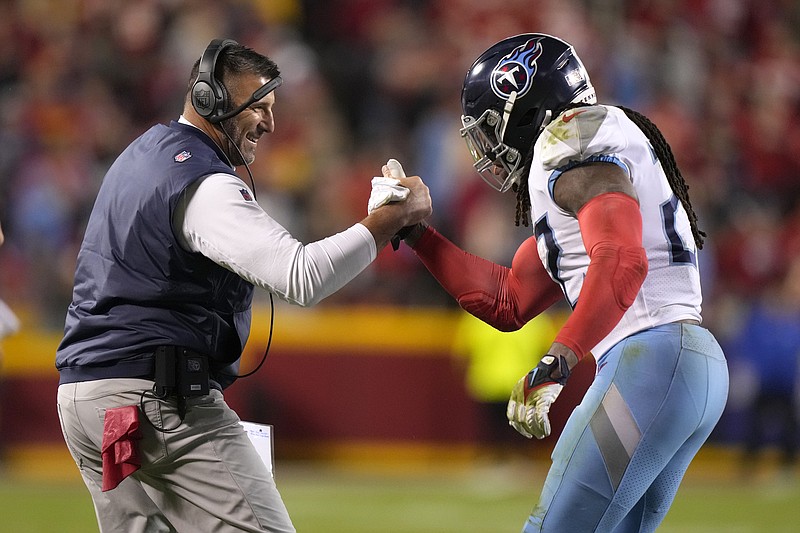 Tennessee Titans running back Derrick Henry is congratulated by head coach Mike Vrabel, left, after scoring during the first half of an NFL football game against the Kansas City Chiefs Sunday, Nov. 6, 2022, in Kansas City, Mo. (AP Photo/Charlie Riedel)