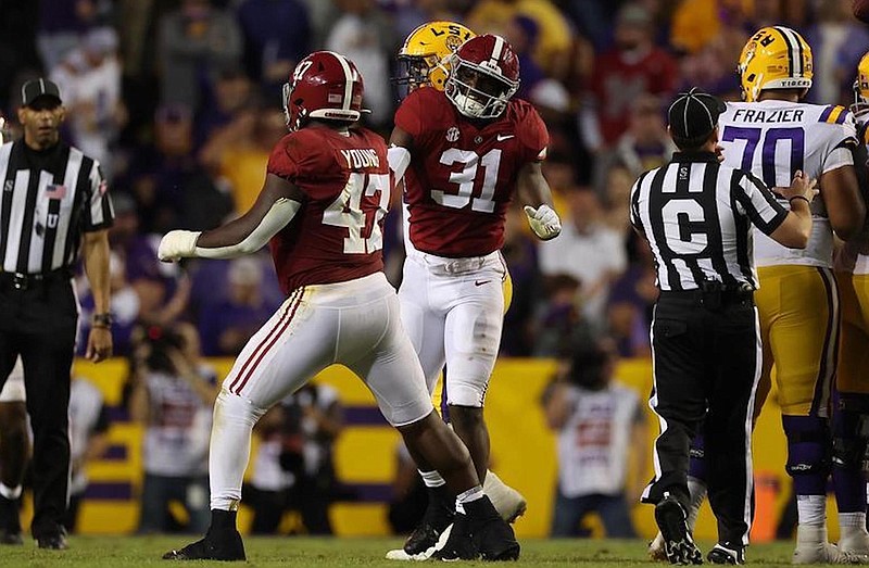 Crimson Tide photo / Alabama defensive lineman Byron Young and outside linebacker Will Anderson celebrate a stop during last Saturday night’s 32-31 overtime loss at LSU.