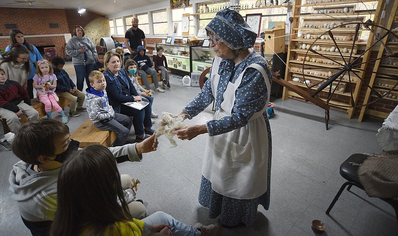 Staff File Photo by Matt Hamilton / Cleveland, Tenn., resident Jo Ann Ratliff talks to children about spinning wool into yarn during Pioneer Days at Audubon Acres on Nov. 17, 2021. This year's celebration opens Tuesday and runs through the weekend.
