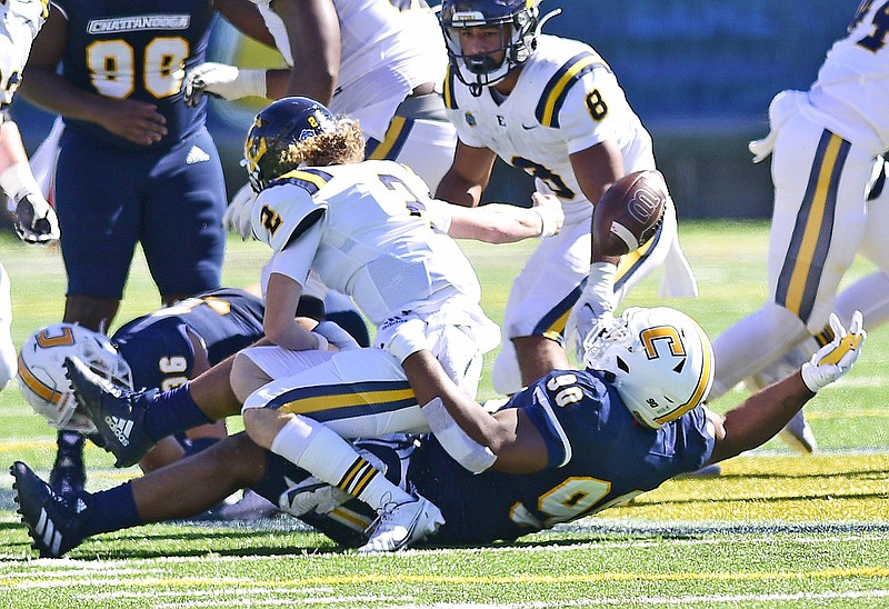 Staff photo by Robin Rudd / UTC's Devonnsha Maxwell (90) forces a fumble that was recovered by teammate Jay Person during a home game against East Tennessee State on Oct. 16, 2021. Maxwell is now a sixth-year senior closing in on the end of a college football career he hopes will include the Mocs' first playoff appearance since he joined the team.