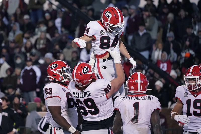 AP photo by Rogelio V. Solis / Georgia receiver Ladd McConkey gets a lift from offensive lineman Tate Ratledge after scoring a touchdown during Saturday night's win at Mississippi State.