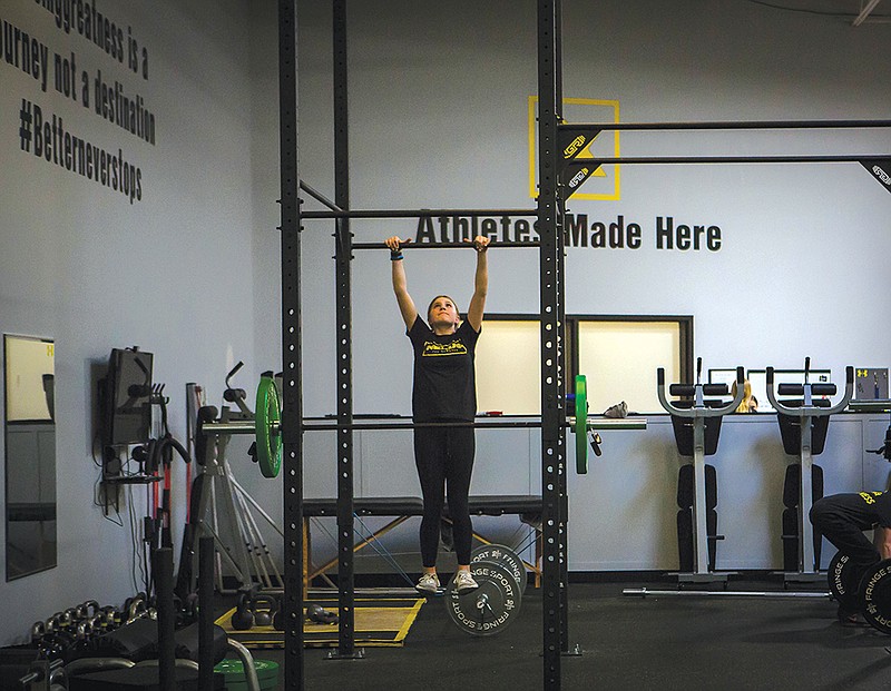 Photo contributed by Scott Stafford / A 13-year-old student practices pull-ups during a training session.