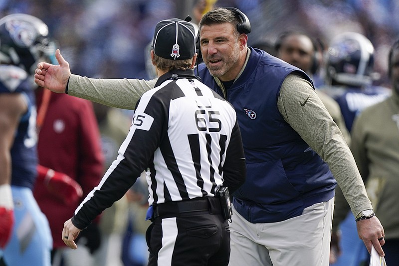 Tennessee Titans head coach Mike Vrabel speaks with line judge Walt Coleman IV (65) during the first half of an NFL football game against the Denver Broncos, Sunday, Nov. 13, 2022, in Nashville, Tenn. (AP Photo/Mark Humphrey)