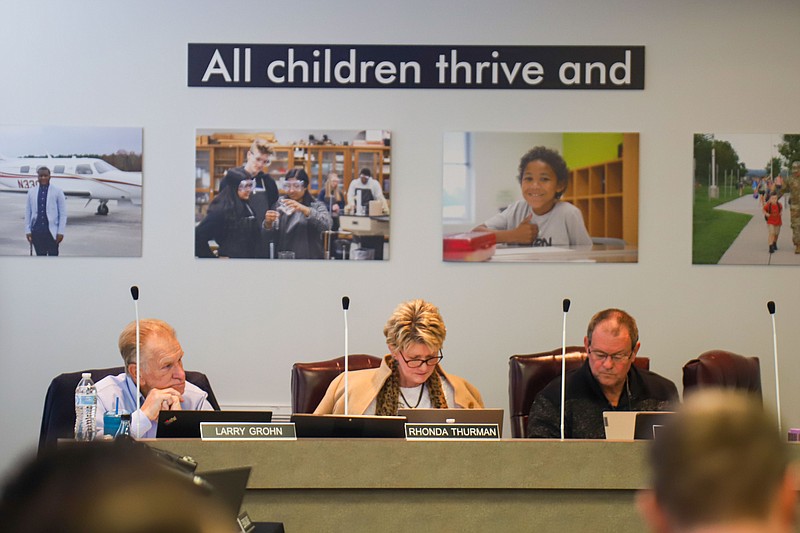 Staff photo by Olivia Ross  / Larry Grohn, Rhonda Thurman and Gary Kuehn sit at a Hamilton County school board meeting on Oct. 20, 2022.