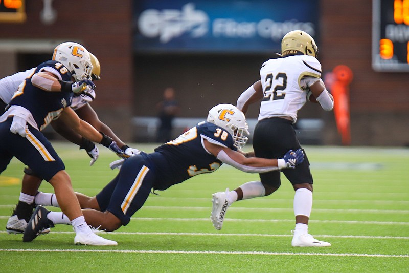 Staff photo by Olivia Ross / UTC senior Austin Collier dives for Wofford's David Legette during the Sept. 3 season opener between SoCon teams at Finley Stadium. Collier, who starred as a running back in high school, has played multiple positions during his time with the Mocs