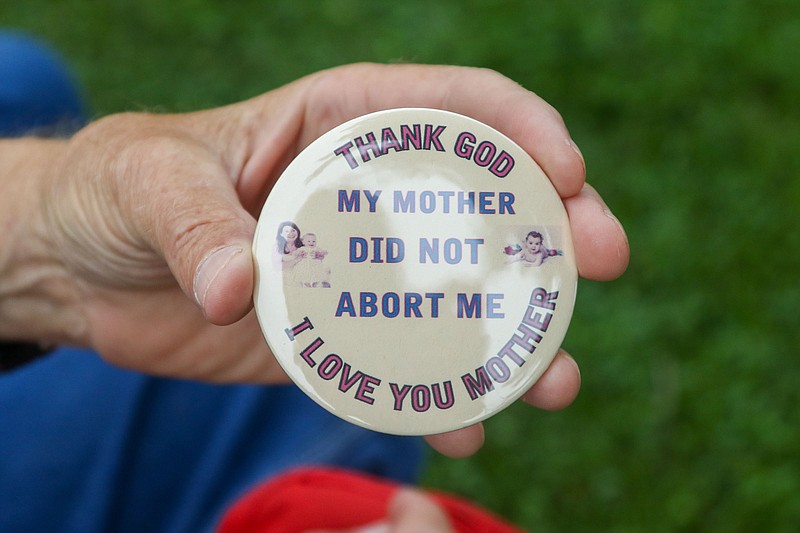 Staff File Photo By Olivia Ross  / Jim Pope hands out buttons reading "Thank God my mother did not abort me" during a Georgia Right to Life rally in front of the Ringgold Courthouse earlier this year.