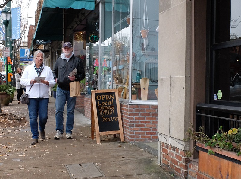 Staff file photo / Susan and Andy Harper walk along Frazier Avenue in November 2021 leading up to Small Business Saturday at Northshore shops in Chattanooga.