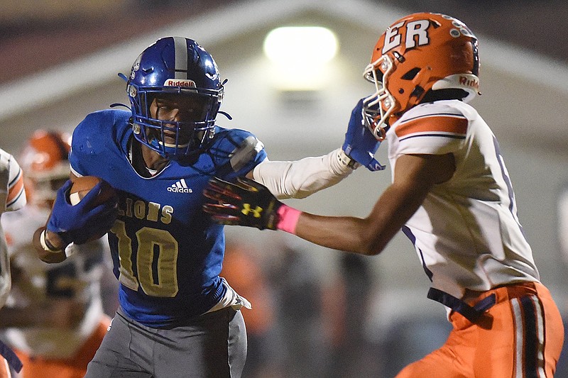 Staff photo by Matt Hamilton / Red Bank (10) AD Crutcher stiff-arms East Ridge (6) Tyree Smith as he attempts the tackle on Friday, October 7, 2022 in Red Bank.