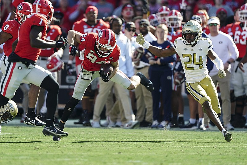 AP photo by John Bazemore / Georgia's Ladd McConkey returns a punt as Georgia Tech defensive back Kenan Johnson (24) closes in during the first half of Saturday's meeting of nonconference rivals at Sanford Stadium in Athens.