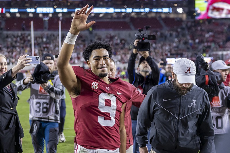 AP photo by Vasha Hunt / Alabama quarterback Bryce Young salutes the fans as he leaves the field after Saturday's Iron Bowl rivalry win against Auburn in Tuscaloosa.