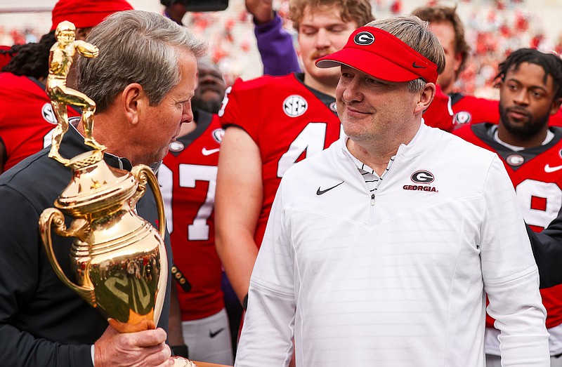 Georgia photo by Tony Walsh / Georgia Gov. Brian Kemp presents Bulldogs coach Kirby Smart with the Governor’s Cup after Saturday’s 37-14 win over Georgia Tech in Sanford Stadium.