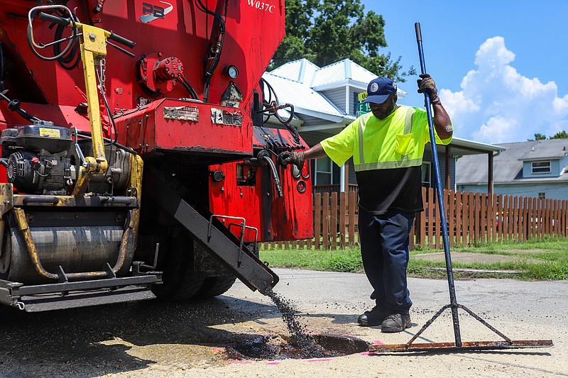 Staff File Photo By Olivia Ross  / One of the many potholes on city streets is repaired by the Chattanooga Public Works crew on July 8, 2022.