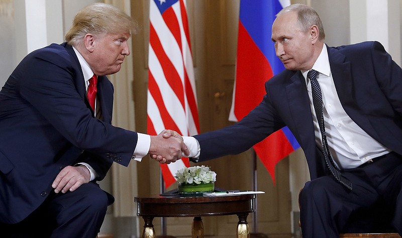 AP file photo / In this file photo taken on July 16, 2018, U.S. President Donald Trump, left, and Russian President Vladimir Putin shake hands at the beginning of a meeting at the Presidential Palace in Helsinki, Finland. Foreign meddling in U.S. elections isn't over, even according to foreign officials.