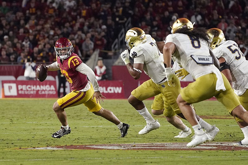 AP photo by Mark J. Terrill / Southern California quarterback Caleb Williams runs away from Notre Dame's defense during the first half of last Saturday's regular-season finale in Los Angeles.