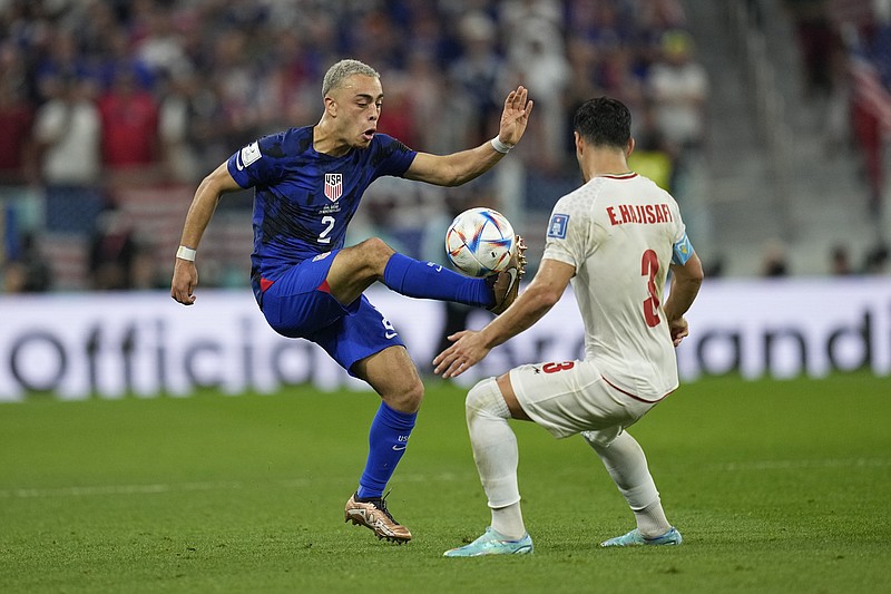 AP photo by Ebrahim Noroozi / U.S. defender Sergino Dest, left, competes with Iran's Ehsan Hajsafi for possession during a World Cup Group B match Tuesday in Doha, Qatar. The Americans won 1-0 to finish second in the group to England and advance to the round of 16, which begins Saturday with a match against the Netherlands.