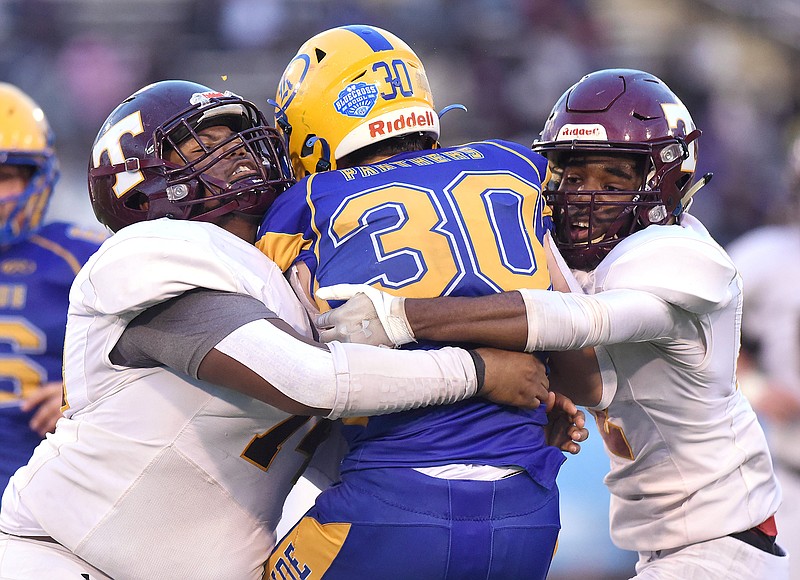 Staff photo by Matt Hamilton / Tyner's Julius Allen, left, and Rayshaun Hinton sandwich Decatur-Riverside's Aiden Creasey to make a tackle during the TSSAA Class 2A BlueCross Bowl state title game Saturday at Finley Stadium.