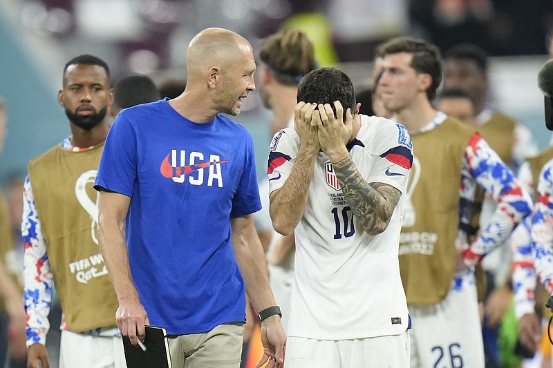 AP photo by Francisco Seco / U.S men's national soccer team coach Gregg Berhalter, left, and winger Christian Pulisic leave the field after Saturday's 3-1 loss to the Netherlands in the round of 16 at the World cup in Doha, Qatar.