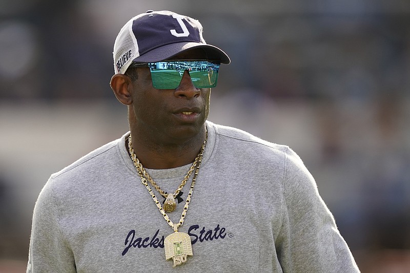 AP photo by Rogelio V. Solis / Jackson State football coach Deion Sanders watches as the Tigers warm up for the SWAC title game against visiting Southern University on Saturday in Mississippi. After coaching Jackson State to a win, Sanders told the team he is leaving to take over at Colorado.