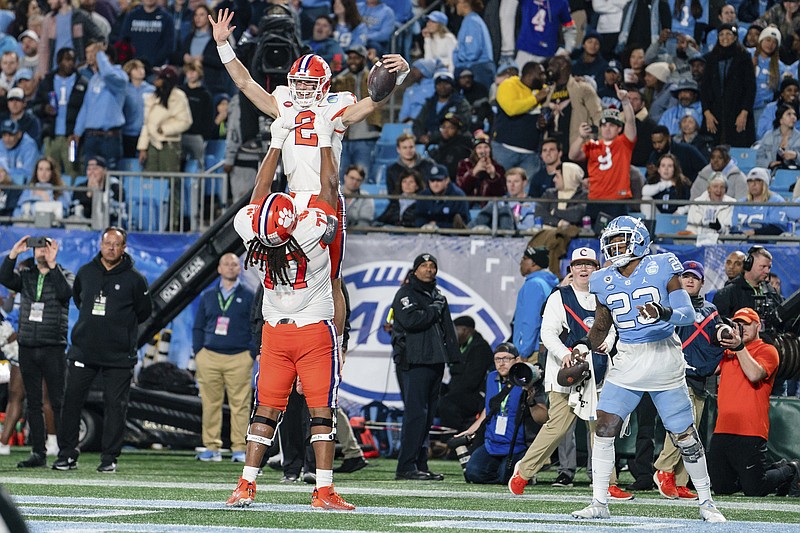 AP photo by Jacob Kupferman / Clemson quarterback Cade Klubnik (2) celebrates his touchdown with offensive lineman Mitchell Mayes in the first half of Saturday's ACC title game against North Carolina.