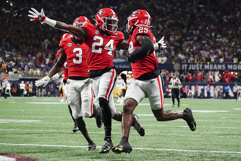 AP photo by John Bazemore / Malaki Starks (24) reacts as fellow Georgia defensive back Christopher Smith (29) returns the Bulldogs' block of an LSU field-goal attempt for a touchdown in the first half of the SEC title game Saturday in Atlanta.