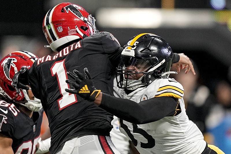AP photo by Brynn Anderson / Atlanta Falcons quarterback Marcus Mariota passes while getting hit by Pittsburgh Steelers linebacker Devin Bush during the second half of Sunday's game.