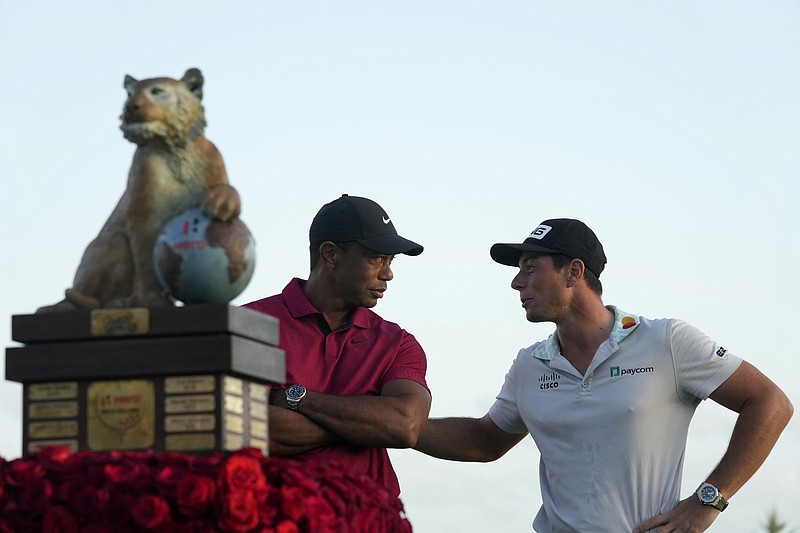 AP photo by Fernando Llano / Viktor Hovland, right, talks to tournament host Tiger Woods after winning the PGA Tour's Hero World Challenge for the second year in a row Sunday at Albany Golf Club in New Providence, Bahamas.
