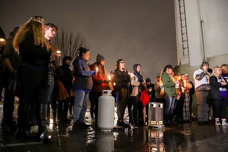 Staff photo by Olivia Ross  / Family, friends, and members of the community hold candles as they listen to stories of Jasmine Pace. A candlelight vigil was held Monday, December 5, 2022 in Coolidge Park for homicide victim Jasmine Pace.