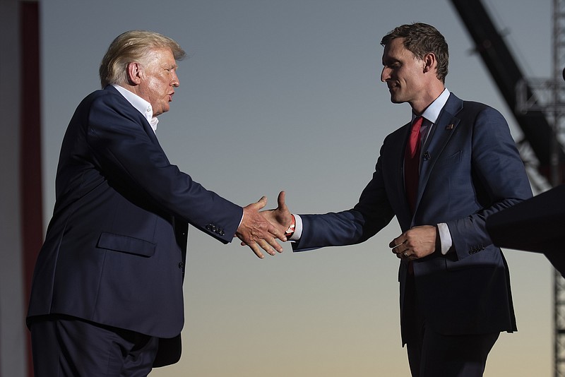 File photo/Rebecca Noble/The New York Times / Former President Donald Trump shakes hands with Blake Masters, who was the Republican candidate and Trump's choice for Senate in Arizona, during the campaign this fall.