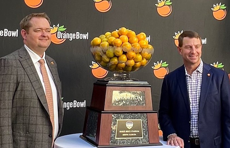Tennessee Athletics photo / Tennessee football coach Josh Heupel, left, and Clemson counterpart Dabo Swinney pose during Wednesday’s Orange Bowl news conference in Miami.