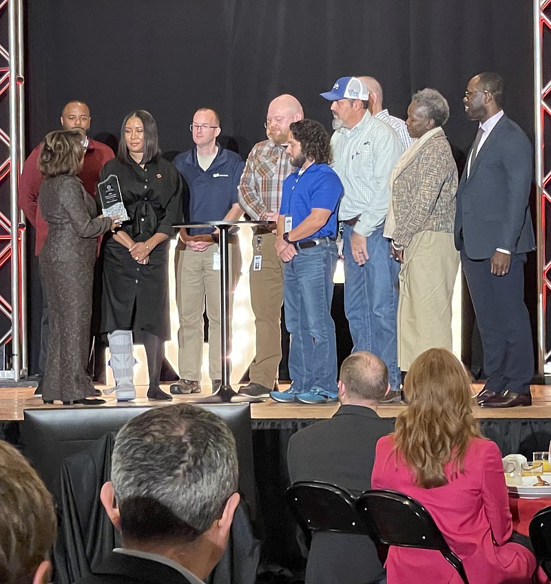 Dorothy Lee Grisham, a member of the executive committee of the Urban League of Greater Chattanooga, presents the Community Impact Award to representatives of EPB  in recognition of the company’s efforts to elevate the community’s standard of living. / Photo by Jennifer McNally