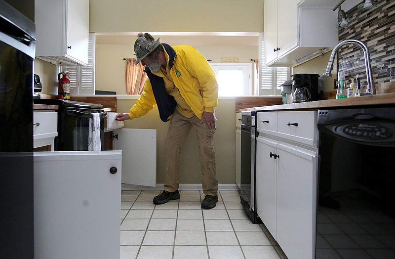 Staff photo / Christian "Thor" Thoreson of Chattanooga Vacation Rentals shows items in the drawers and cabinets in a short-term vacation rental property that he and his wife manage Thursday, January 10, 2019 in Chattanooga.