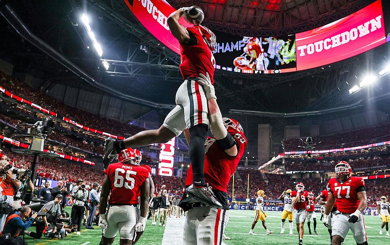 Georgia photo by Tony Walsh / Georgia running back Kenny McIntosh receives a lift from right guard Tate Ratledge after McIntosh’s 8-yard touchdown run during the 50-30 thumping of LSU in the SEC title game on Dec. 3 in Atlanta.
