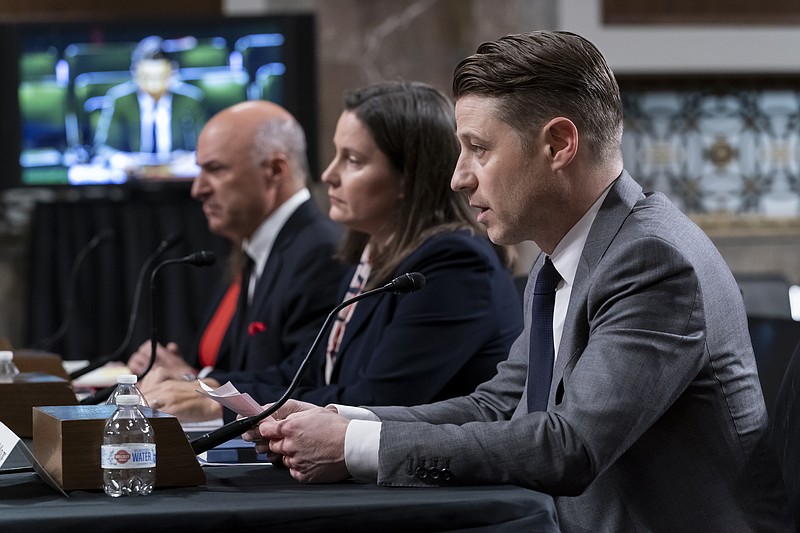 Actor Ben McKenzie testifies during a Senate Banking Committee hearing on cryptocurrency and the collapse of the FTX crypto exchange and its founder Sam Bankman-Fried, at the Capitol in Washington, Wednesday, Dec. 14, 2022. He is joined at left by investor Kevin O'Leary, and Cato Institute Center for Monetary and Financial Alternatives Director of Financial Regulation Studies Jennifer Schulp. (AP Photo/J. Scott Applewhite)