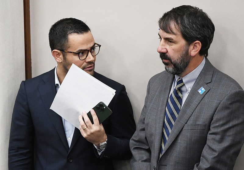 Staff Photo by Robin Rudd /  Hamilton County Mayor Weston Wamp and Schools Superintendent Justin Robertson confer during a Hamilton County Commission meeting on Wednesday.