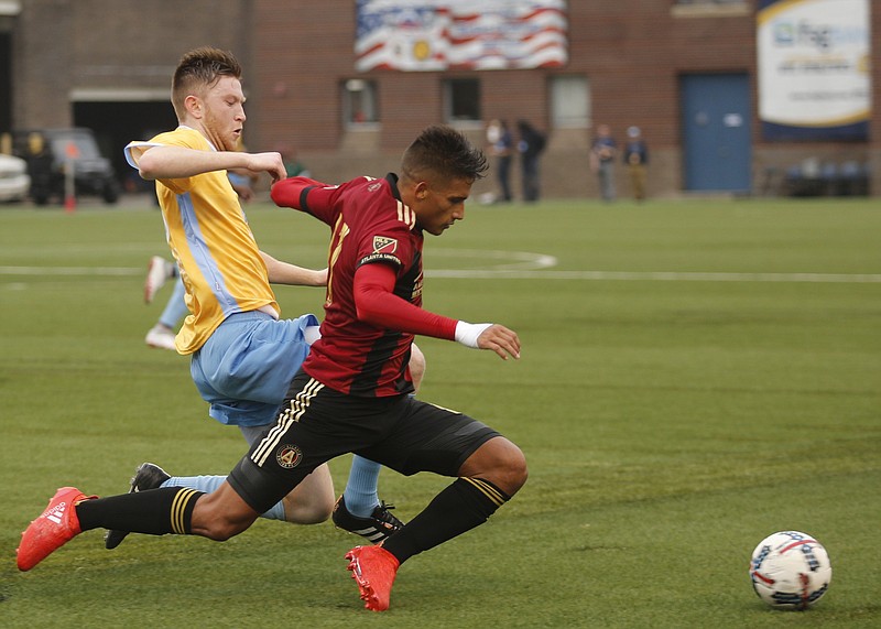 Staff photo / Chattanooga FC's Danny Whitehall, left, tackles Atlanta United's Yamil Asad during a friendly match at Finley Stadium on Feb. 11, 2017. The clubs announced Friday that they will meet in another exhibition at Finley on Jan. 28.