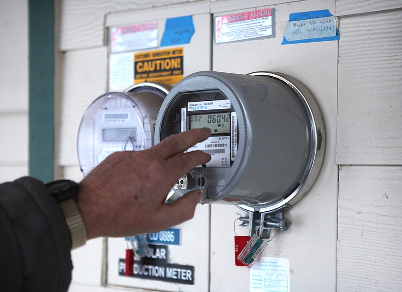 (Tony Overman/The Olympian via Tribune / Meters track the electric generation from solar panels in 2012 at Dennis Kaech's home in Olympia, Wash.