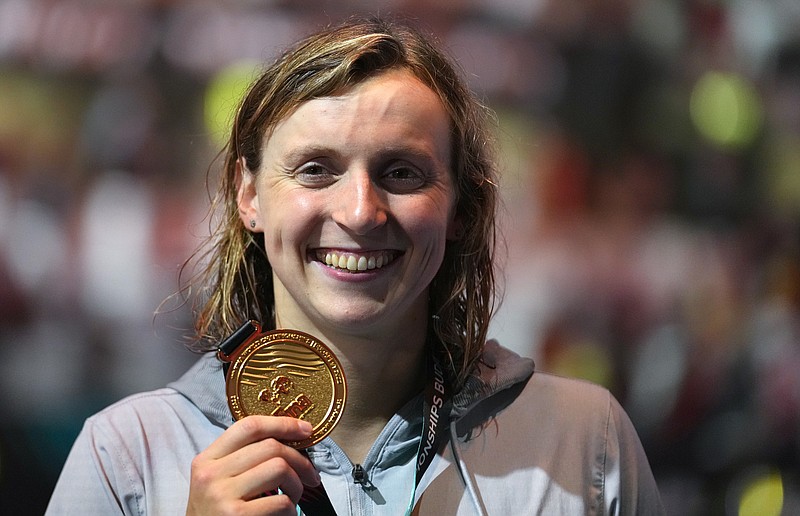 AP photo by Petr David Josek / U.S. swimmer Katie Ledecky shows her gold medal after winning the women's 800-meter freestyle final on June 24 at the world championships in Budapest, Hungary.