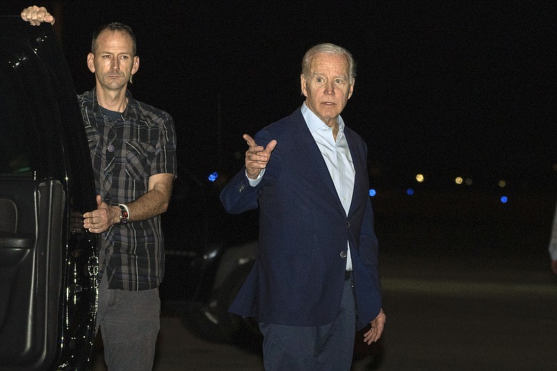 FILE - President Joe Biden arrives at Henry E. Rohlsen Airport, in St. Croix, U.S. Virgin Islands, late Tuesday, Dec. 27, 2022. Biden on Thursday signed a $1.7 trillion spending bill that will keep the federal government operating through the end of the federal budget year in September 2023, and provide tens of billions of dollars in new aid to Ukraine for its fight against the Russian military. (AP Photo/Manuel Balce Ceneta, File)