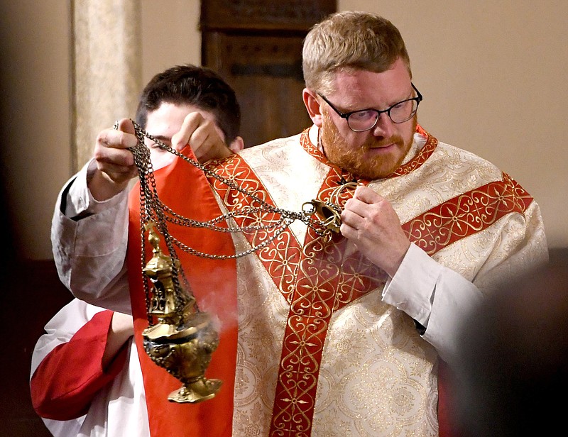 Staff Photo by Robin Rudd / The Very Rev. David Carter, pastor and rector of the Basilica of Sts. Peter and Paul, uses a thurible June 19 to incense the altar of the 8th Street church during a Mass in the Most Ancient Use of the Roman Rite.