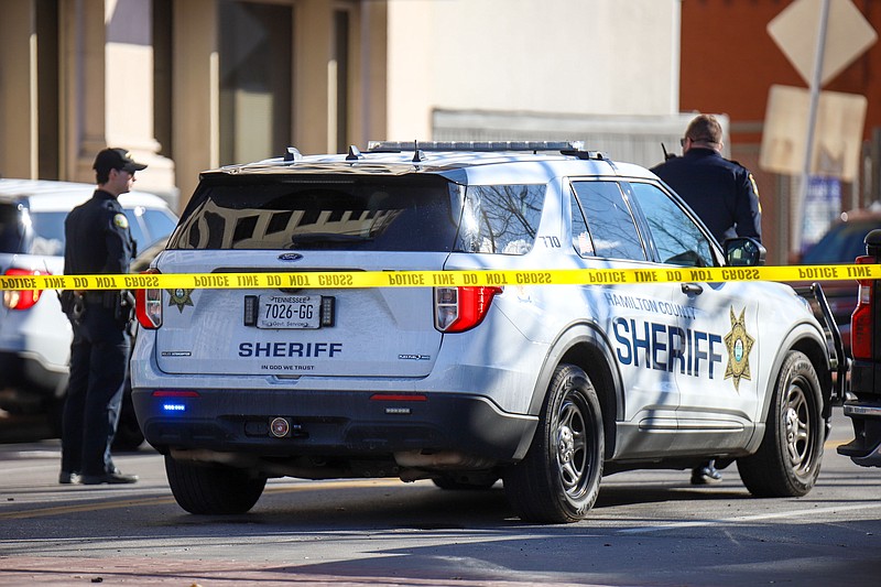 Staff Photo by Olivia Ross / Police stand along M.L. King Boulevard and Lindsay Street on Thursday, with surrounding roads blocked off by officers and police tape.