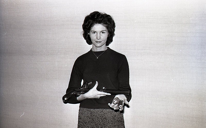 Chattanooga News-Free Press photo via ChattanoogaHistory.com. Darlene Peavy is shown with two of her pistols at the Smoky Mountain Gun Collectors Association show at the Hotel Patten in December 1964.