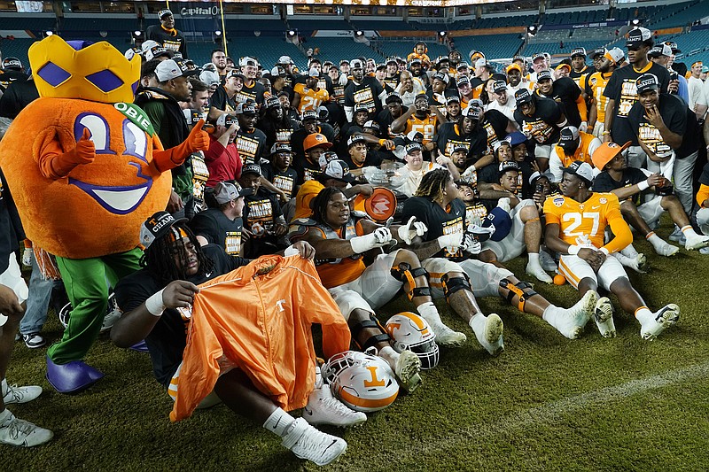 AP photo by Lynne Sladky / Tennessee football players and coaches pose with the Orange Bowl mascot after beating Clemson 31-14 on Friday night in Miami Gardens, Fla. Tennessee offensive lineman Darnell Wright and linebacker Aaron Beasley made the AP's all-bowl team announced Thursday.