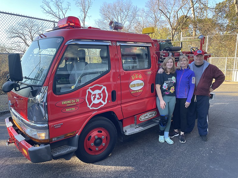 Staff photo by Mark Kennedy / From left, Sydney, Shannon and Barry Twitchell, of East Brainerd, show off their new fire truck.