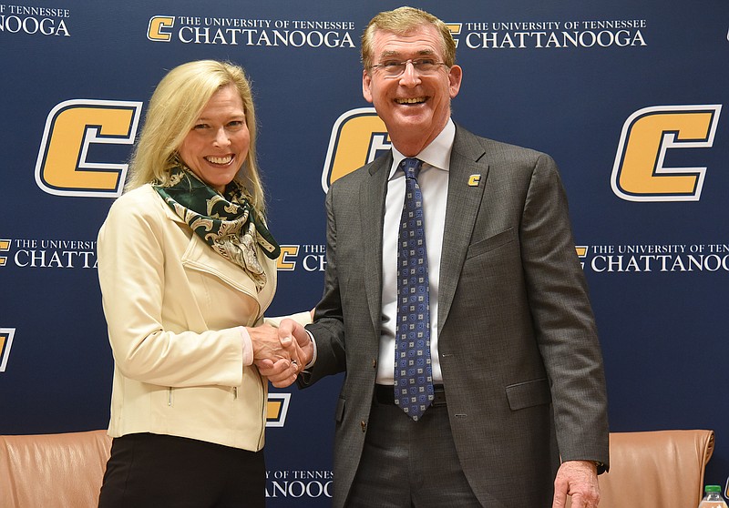 Staff photo by Matt Hamilton / Chattanooga State Community College President Rebecca Ashford, left, and University of Tennessee at Chattanooga Chancellor Steve Angle shake hands after the signing ceremony at UTC on Friday.