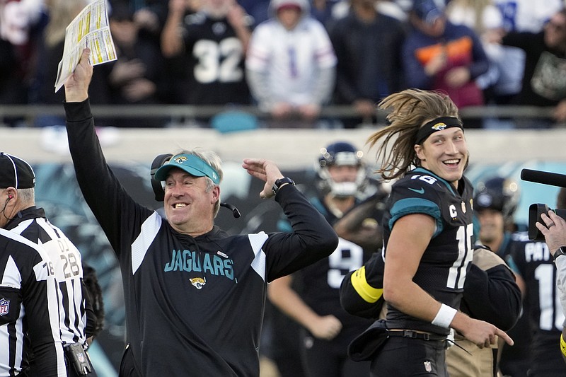 AP photo by John Raoux / Jacksonville Jaguars coach Doug Pederson, left, celebrates with quarterback Trevor Lawrence after defeating the visiting Dallas Cowboys in overtime on Dec. 18.