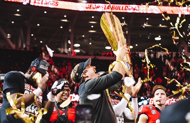 University of Georgia photo / Georgia football coach Kirby Smart holds up his second consecutive national championship trophy following Monday night’s 65-7 rout of TCU at SoFi Stadium in Los Angeles.