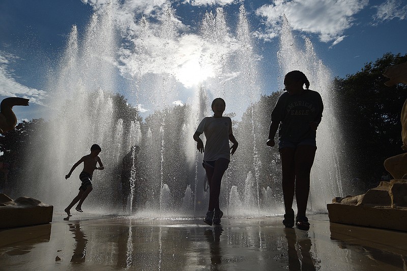 Staff Photo by Matt Hamilton / Children cool off July 2 in the fountain at Coolidge Park in Chattanooga. A new report says access to mental health care professionals and foster car instability are among the issues facing Tennessee children.